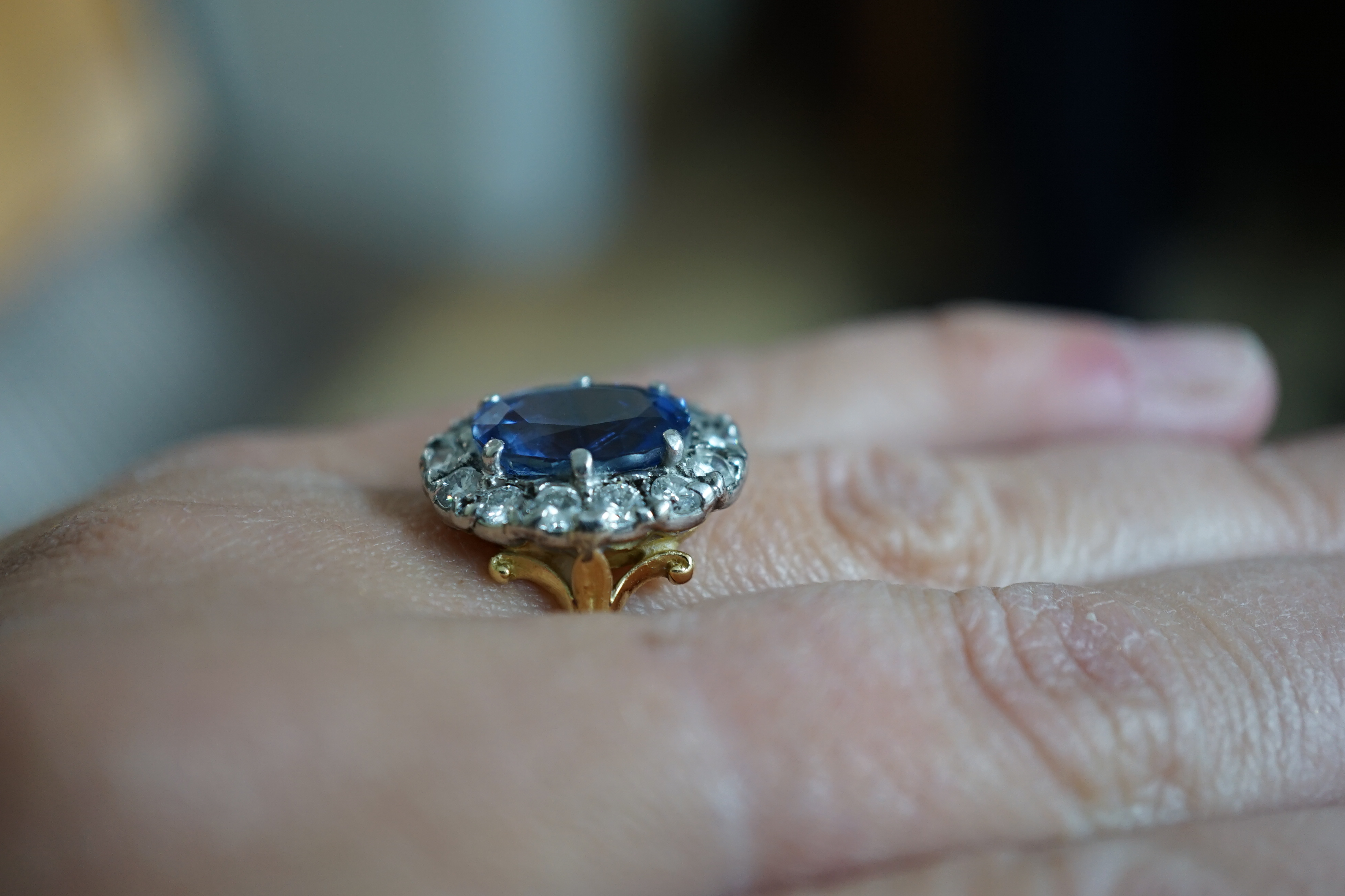 An 18ct gold, sapphire and diamond set oval cluster ring